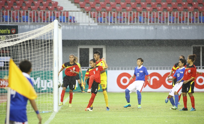 Mas (blue) vs Timor (red). Timor Natacha Sarmento tries to clear but turns the ball into her own net