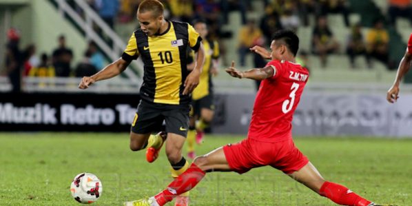 Wan Zack Haikal Wan Nor (left) skips past Zaw Min Tun
